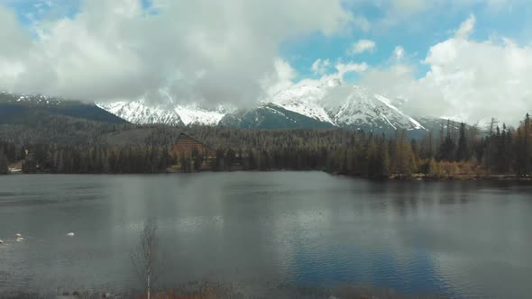 Aerial View of Strbske Pleso in the Clouds and Snowy Mountains. Slovakia alt