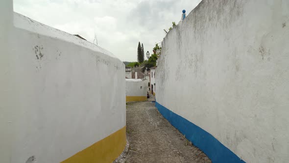 Narrow Alley in Castle of Óbidos with Blue and Yellow Paints Painted on Houses Walls