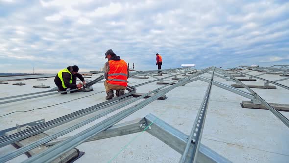 Workers installing solar panels outdoors. Male technician installing photovoltaic solar panels alt