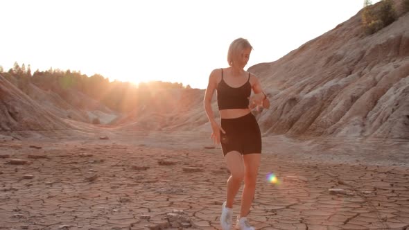 Woman dancing on lifeless dried locality