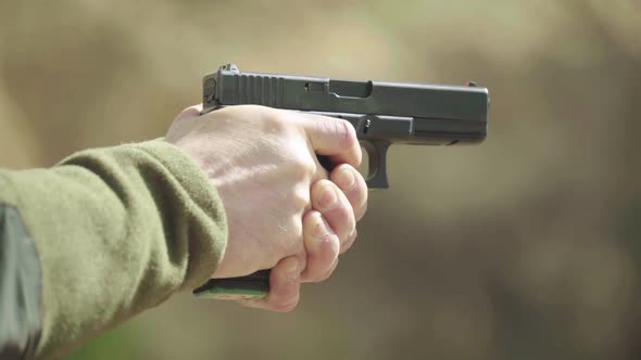 Close-up Shot of a Pistol. Slow Motion. alt