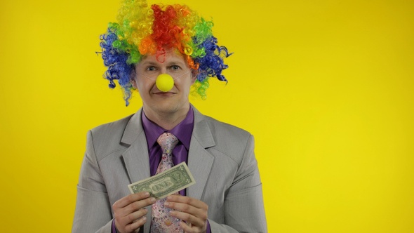 Clown Businessman Entrepreneur in Wig Holds One Buck Money Income and Loses It alt