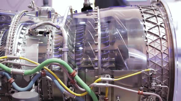 a close up of a jet engine without the case. you can look into the engine and see the spinning fans. alt