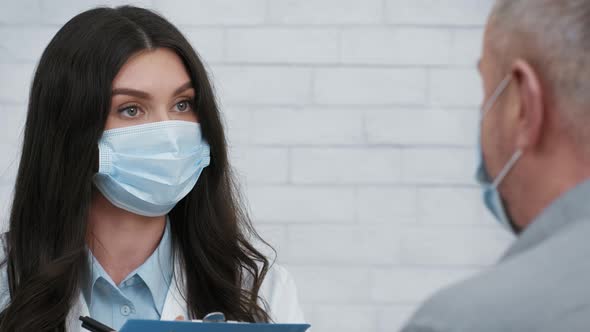 Female Doctor Talking With Senior Male Patient Having Appointment Indoors alt