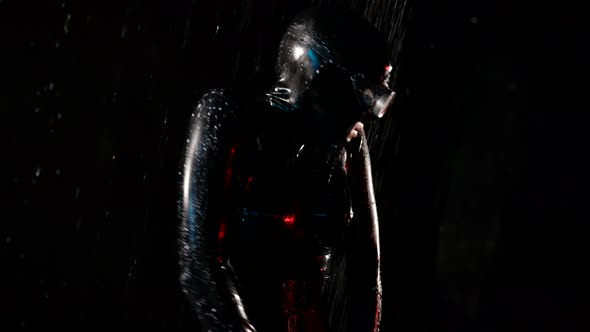 Voluptuous Woman in Black Latex Suit From Sex Shop and Full Face Mask is Dancing in Rain at Night alt