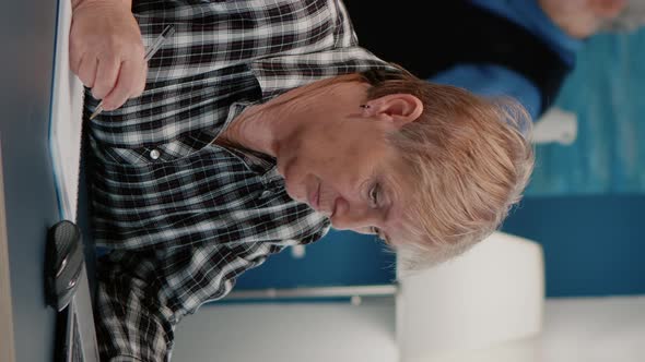 Vertical Video Old Woman Entrepreneur Checking Financial Project Taking Notes alt