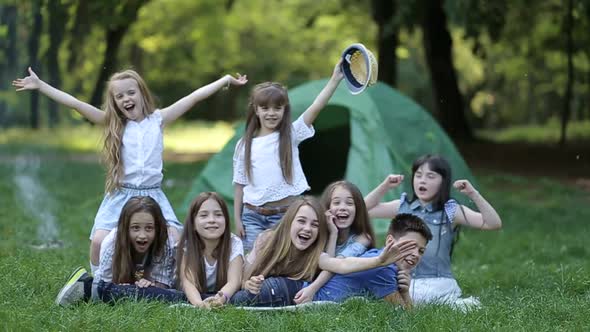Children in the camp by the bonfire. Group teen outdoors at summer alt