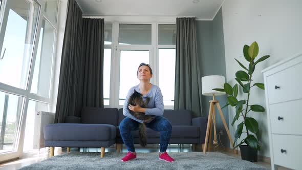 Woman Squats with a Cat in Her Arms Slow Motion alt