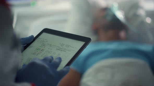 Doctor Holding Tablet Screen Checking Patient Medical History in Ward Closeup alt
