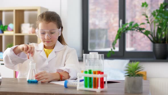 Girl with Test Tubes Studying Chemistry at Home alt