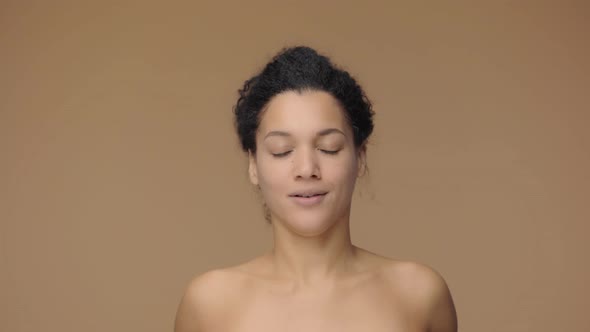 Beauty Portrait of Young African American Woman Having Fun Smiling Holding Avocado Halves in Hands alt