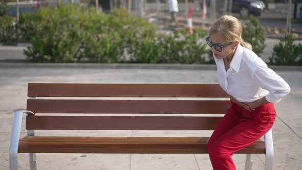 Bench in Sunny City with Unwell Businesswoman Having Stomach Pain Sitting Down Asking Help As People alt