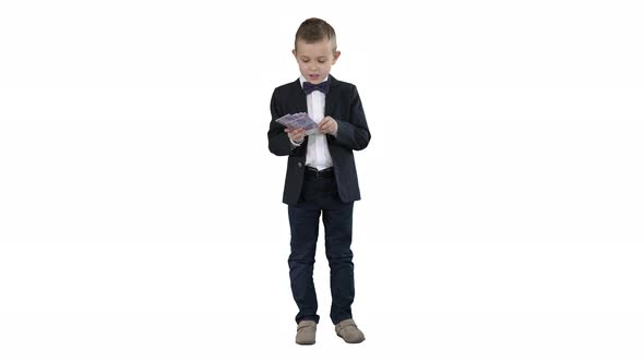 Little Boy in a Suit Counting Money on White Background alt