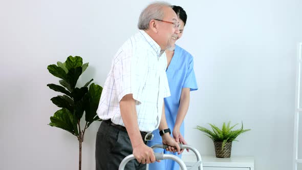 Asian young nurse take care a senior with a walker.