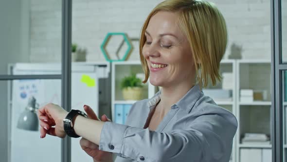 Laughing Women Using Smartwatches alt