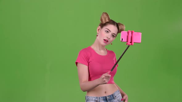 Girl Doing Selfie on Selfie Stick. Green Screen. Slow Motion alt