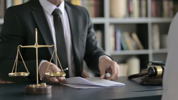 Close Up Shoot of Lawyer Hand Shaking and Document Check in Court Room alt