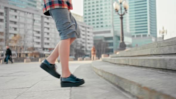 Woman Walking Upstairs Outdoors. Female Legs in Platform Shoes Climbing Up alt