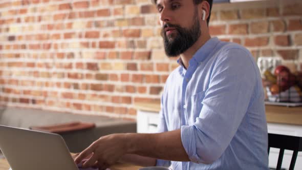 Video of businessman working on a laptop at home. Shot with RED helium camera in 8K. alt