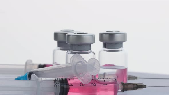 Syringes and Vials of Vaccine From the Virus Covid 19 alt