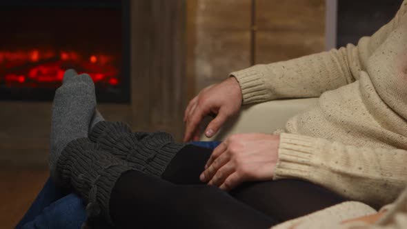 Girl Playing with Her Feet Over Boyfriend Legs alt