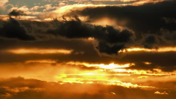Dramatic Sunset in the Sky Through Orange Layered Cumulus Clouds Timelapse alt