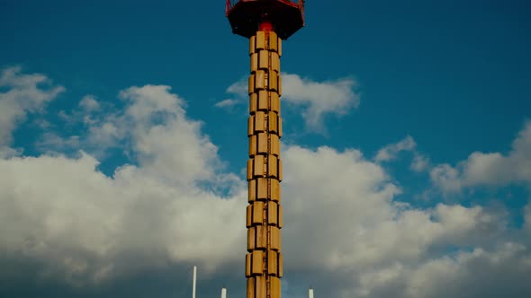 Antenna of Television Tower Against Blue Sky with Clouds