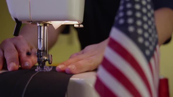 Tailor Sewing Next To An American Flag 30