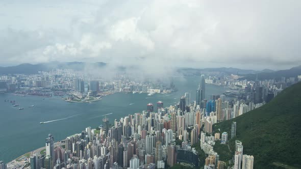 Aerial perspective though clouds of Victoria Habour, Hong Kong skyscrapers Island District alt