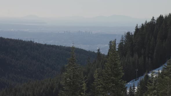 View of Top of Grouse Mountain Ski Resort with the City in the Background alt