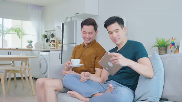 Attractive romantic male lgbtq couple take care and serve a cup of coffee to young boyfriend. alt