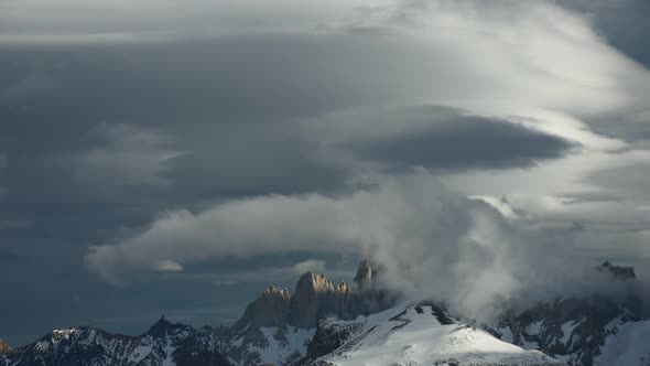 Time lapse of clouds swirling around jagged peaks in Patagonia, South America alt