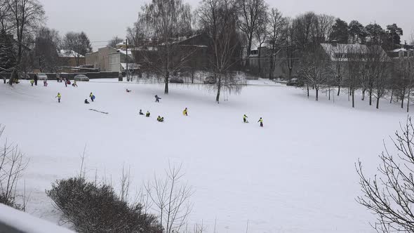 Little Children Group Sledding at Winter Time
