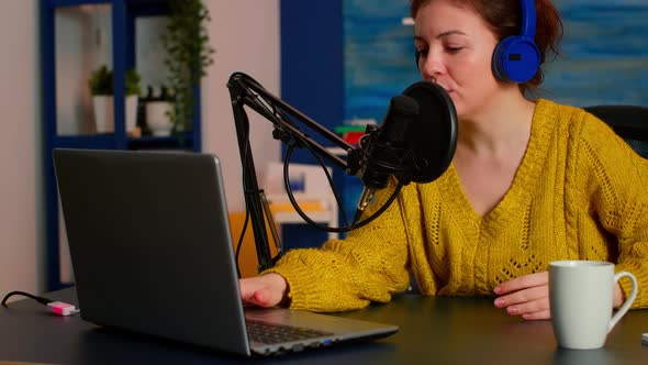 Woman Podcaster Recording Audio Podcast on Laptop Computer alt
