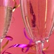 Pouring sparkling wine into glasses on a pink background with confetti in the form of hearts - VideoHive Item for Sale