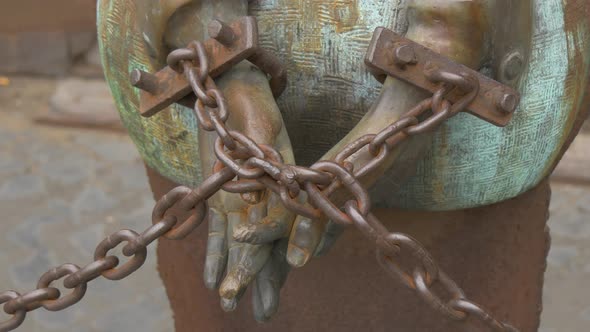 Sculpted hands in chains 