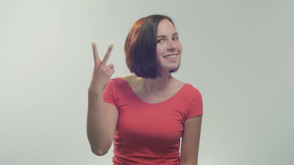 Young woman showing peace sign alt