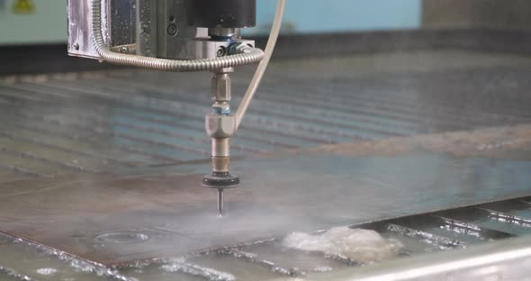 Waterjet High Pressure CNC Machine is Cutting Out a Holes on a Metal Sheet