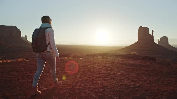 Happy Elevated Woman in Slow Motion Walking By Red Desert in Monument Valley alt