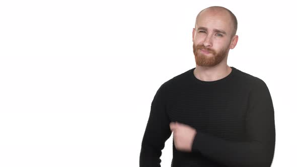 Portrait of Upset Guy with Red Beard and Mustaches Expressing Dislike with Gesturing Thumb Down at alt