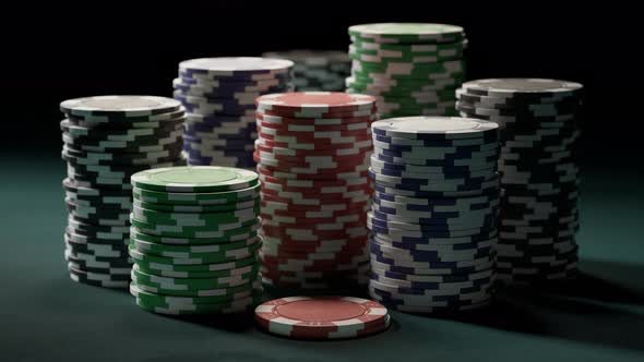Casino chips or tokens in stacks on a green gaming table. Las Vegas gambling. alt