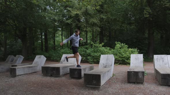 Athlete Leaping Across Concrete Blocks To Exercise