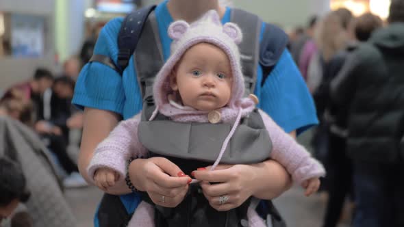 Cute Baby in Mothers Kangaroo Carrier alt