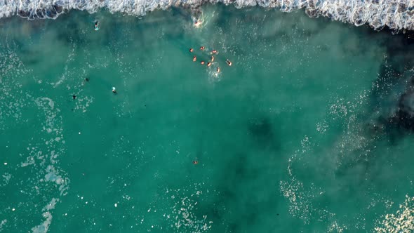 Top down view of a group of people having fun in strikingly blue ocean water