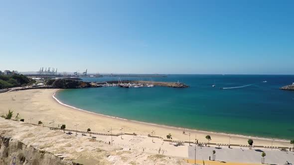 Upwards Pan Shot From Stone Wall Pointing at Ocean in Sines Portugal alt