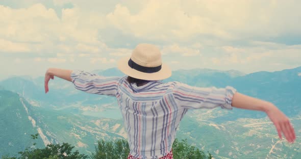 Happy Traveler Arms Wide Open to Sides on Mountain Top alt