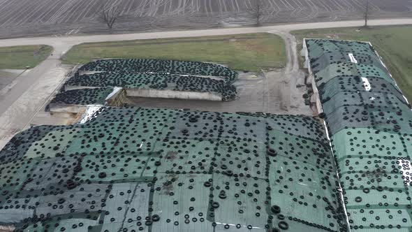 Aerial View of Large Pile of Silage Covered with Plastic Film and Used Tires alt