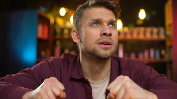 Disappointed Caucasian Football Fan Watching Game in Pup, Team Losing Game alt