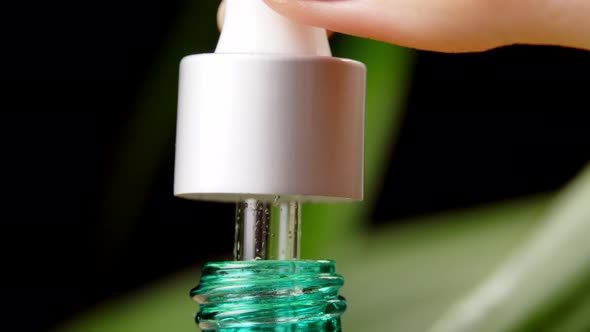 Moisturizing serum, vitamin for skin of face. A woman's hand alt