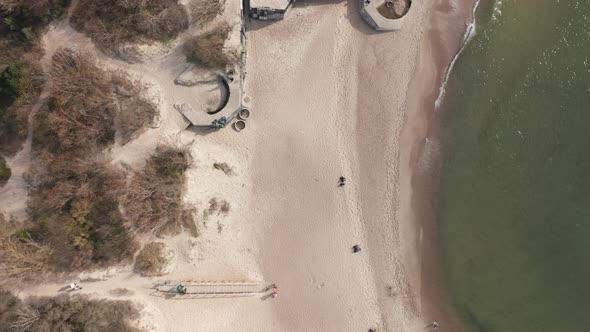 AERIAL: Top View of Sandy Melnrage Beach in Klaipeda with old World War II Battery